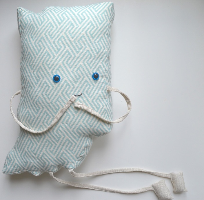 cute indiana pillow face using a backstitch with embroidery thread