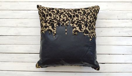 black floral pillow with a black indy skyline sewn on