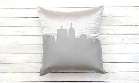silver square pillow with Indianapolis skyline on it